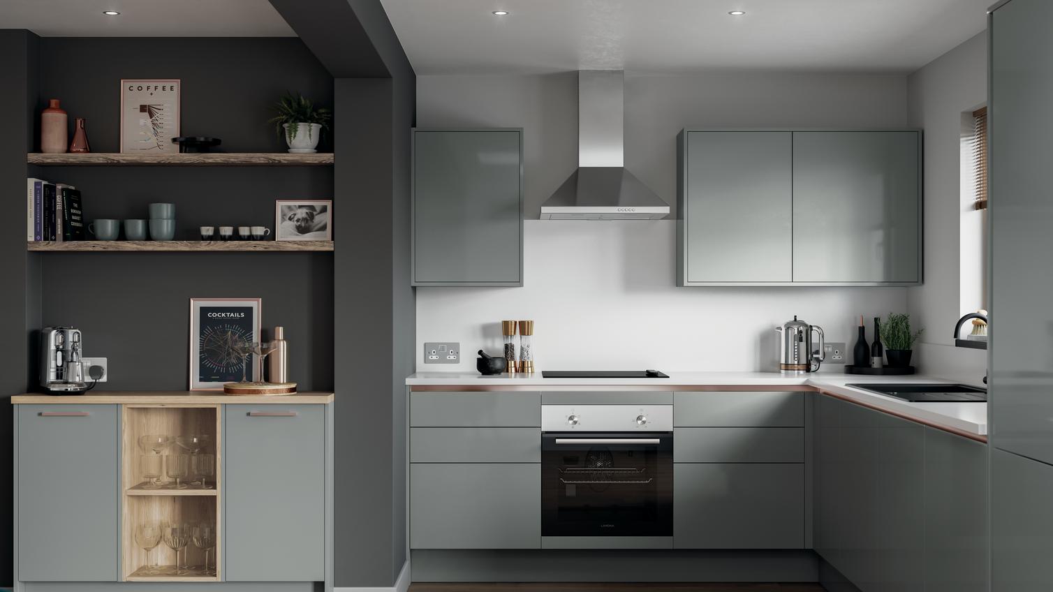 Small l-shape kitchen with grey slab doors and copper trims for a handleless look. Has a single oven and a silver extractor.